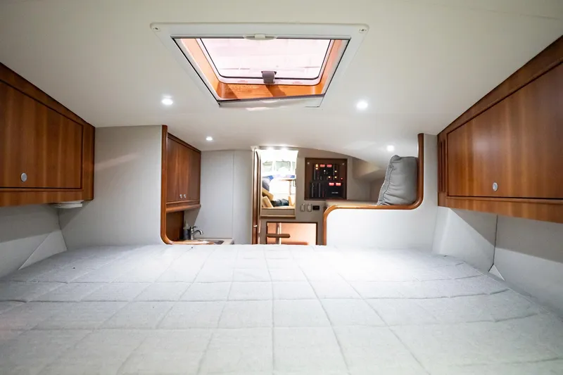 Here Fishy Fishy Yacht Photos Pics Interior of 2012 Winter Custom Yachts 38 Express, featuring cozy cabin with wood accents.