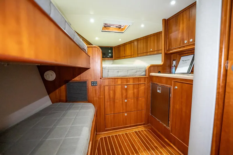 Here Fishy Fishy Yacht Photos Pics Luxurious 2012 Winter Custom Yachts 38 Express cabin with wooden interior and cozy sleeping area.