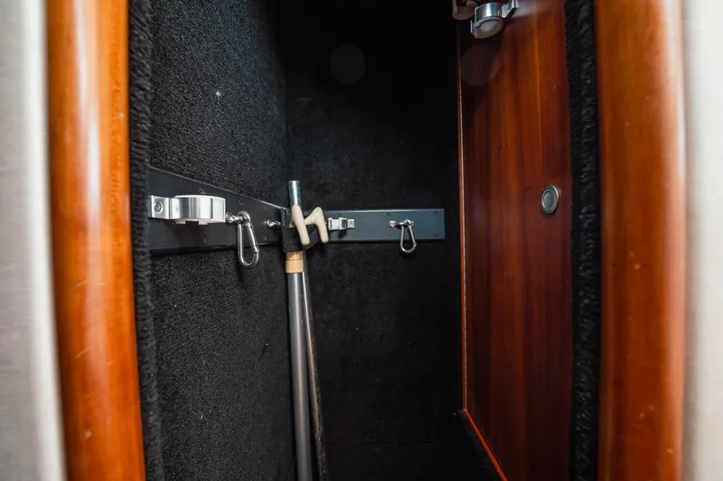 Here Fishy Fishy Yacht Photos Pics Storage compartment in a 2012 Winter Custom Yachts 38 Express, featuring hooks and a pole.