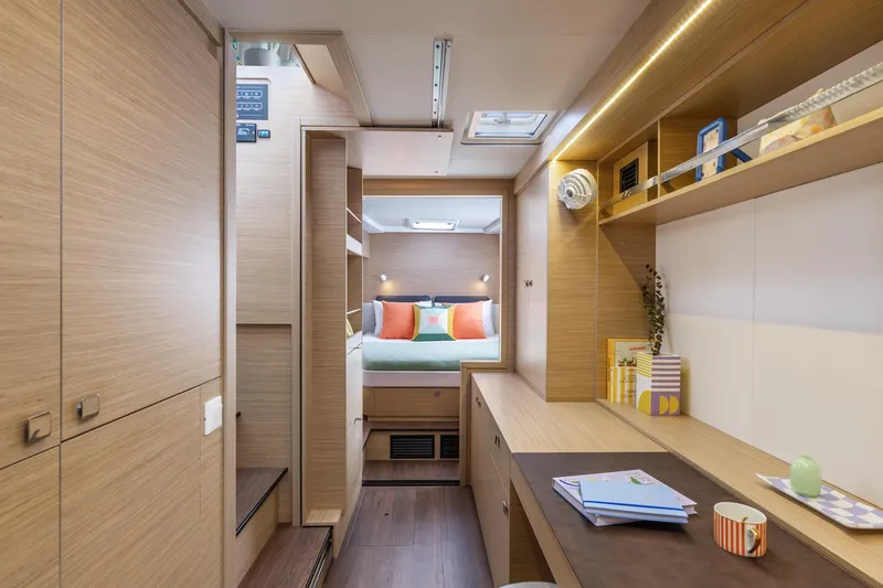  Yacht Photos Pics Luxurious interior of 2026 Lagoon 43 yacht with modern wood finish and cozy bedroom.