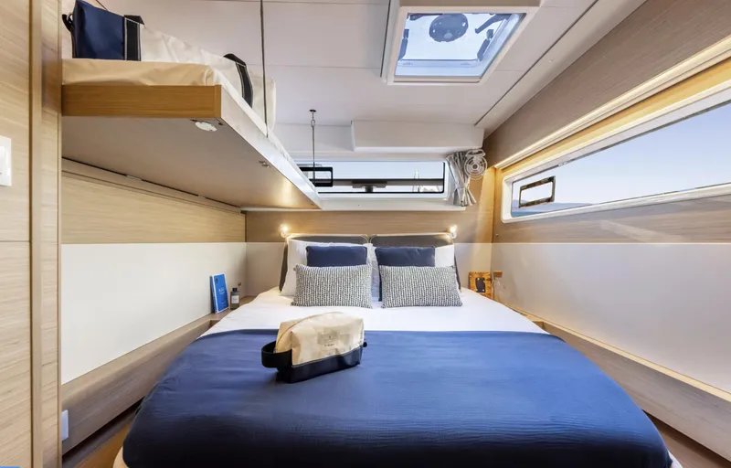  Yacht Photos Pics Luxurious cabin interior of 2026 Lagoon 43 yacht with modern bedding and natural light.