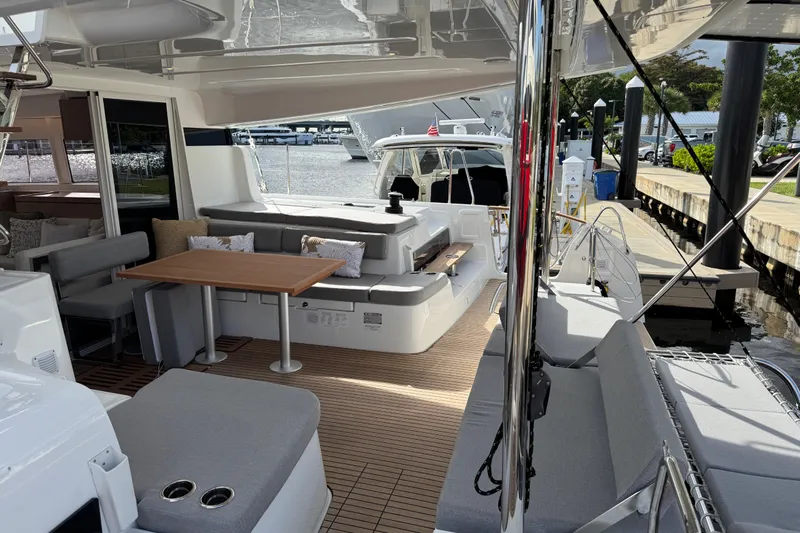  Yacht Photos Pics Luxurious 2026 Lagoon 43 yacht interior with elegant seating and dining area at the dock.
