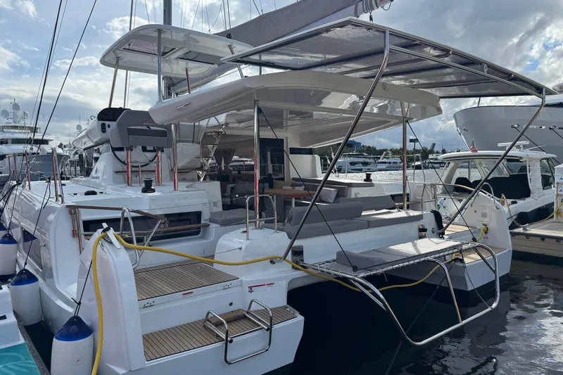  Yacht Photos Pics 2026 Lagoon 43 yacht docked, showcasing sleek design and spacious deck area.