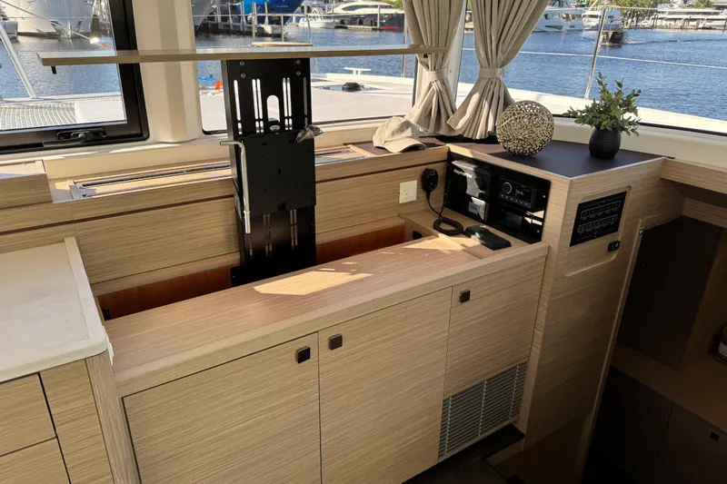  Yacht Photos Pics Interior of 2026 Lagoon 43 yacht with modern wooden cabinetry and electronics.