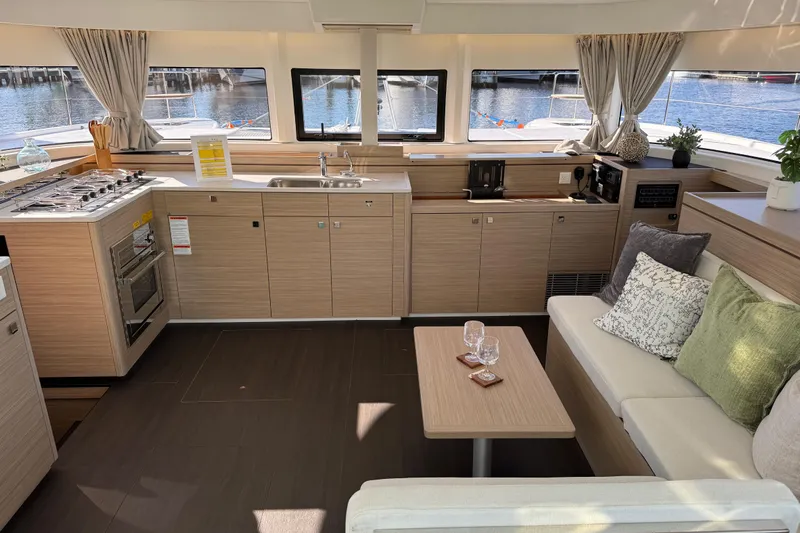  Yacht Photos Pics Modern interior of 2026 Lagoon 43 yacht with kitchen and seating area.