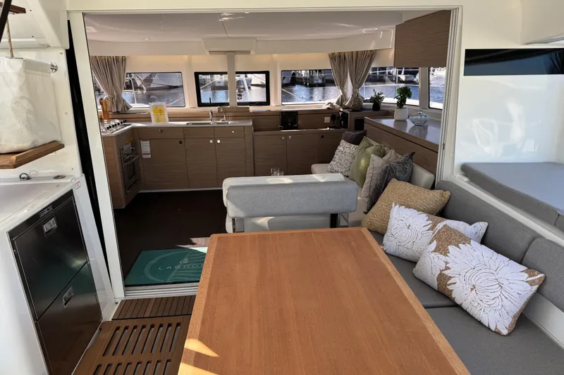  Yacht Photos Pics Luxurious interior of 2026 Lagoon 43 yacht with modern kitchen and cozy seating area.