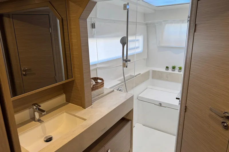  Yacht Photos Pics Modern bathroom in 2026 Lagoon 43 yacht with sleek design and natural wood accents.