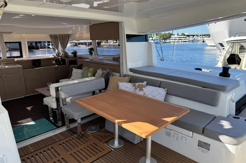  Yacht Photos Pics Luxurious interior of 2026 Lagoon 43 yacht with elegant seating and dining area.