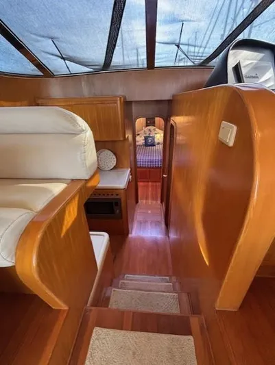 Marsea Yacht Photos Pics Interior of 1994 Johnson High Tech Euro 56 yacht with wooden finishes and cozy seating.