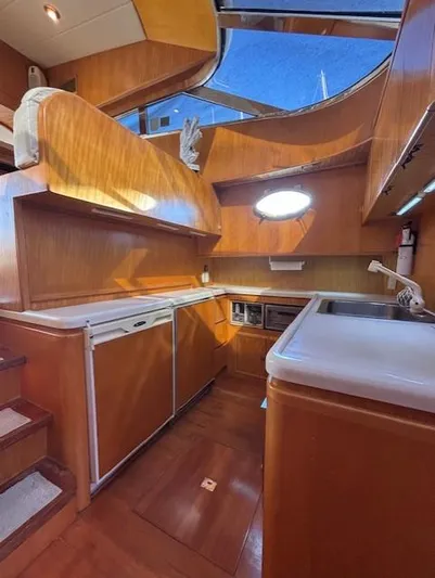Marsea Yacht Photos Pics 1994 Johnson High Tech Euro 56 yacht kitchen with wood finish and modern appliances.