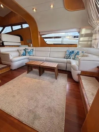 Marsea Yacht Photos Pics Luxurious yacht interior with white leather seating, wooden accents, and decorative pillows, Johnson High Tech Euro 56.