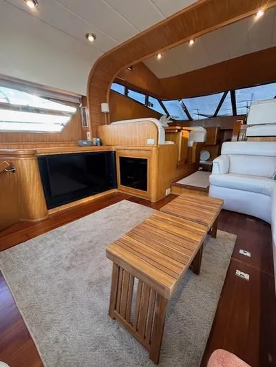 Marsea Yacht Photos Pics Luxurious interior of a 1994 Johnson High Tech Euro 56 yacht with wooden accents and plush seating.