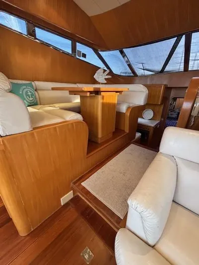 Marsea Yacht Photos Pics Luxurious interior of 1994 Johnson High Tech Euro 56 yacht with wooden accents and white seating.