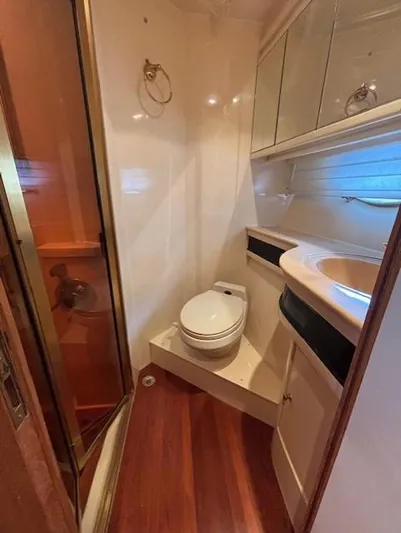 Marsea Yacht Photos Pics Compact bathroom in 1994 Johnson High Tech Euro 56 yacht with wood flooring and shower.