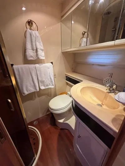 Marsea Yacht Photos Pics Luxurious bathroom in 1994 Johnson High Tech Euro 56 yacht, featuring elegant fixtures and wooden flooring.