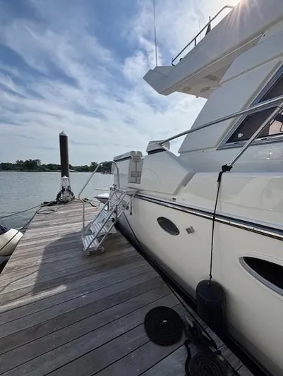Marsea Yacht Photos Pics Luxury yacht "Johnson High Tech Euro 56" docked at a serene marina, 1994 model.