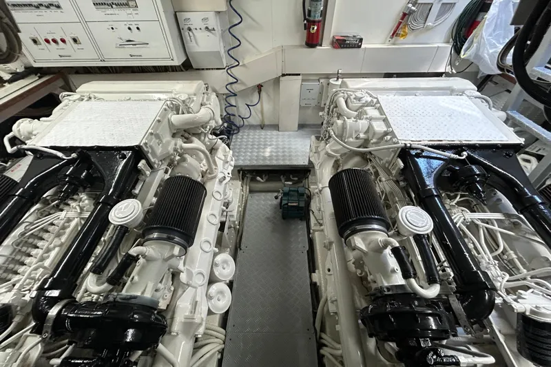 Gabriela G Yacht Photos Pics Engine room of a 2001 Mangusta 72 yacht, featuring dual engines and control panels.