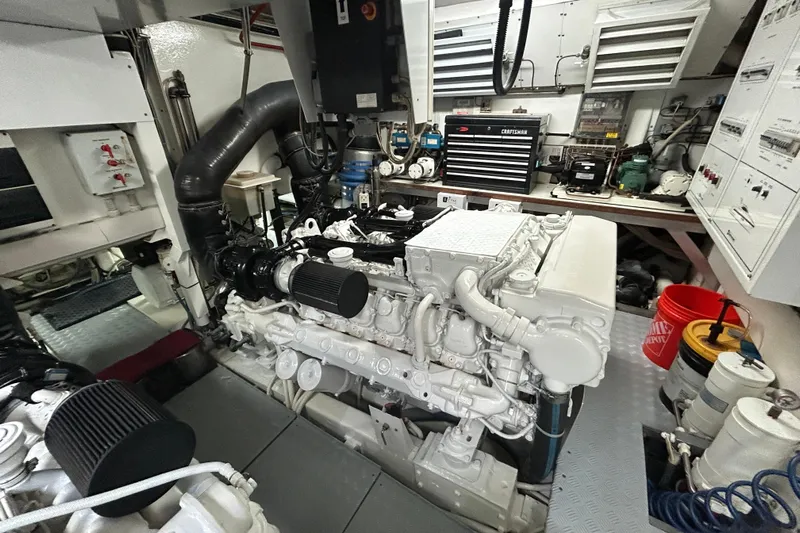 Gabriela G Yacht Photos Pics Engine room of a 2001 Mangusta 72 yacht, featuring machinery and tools.
