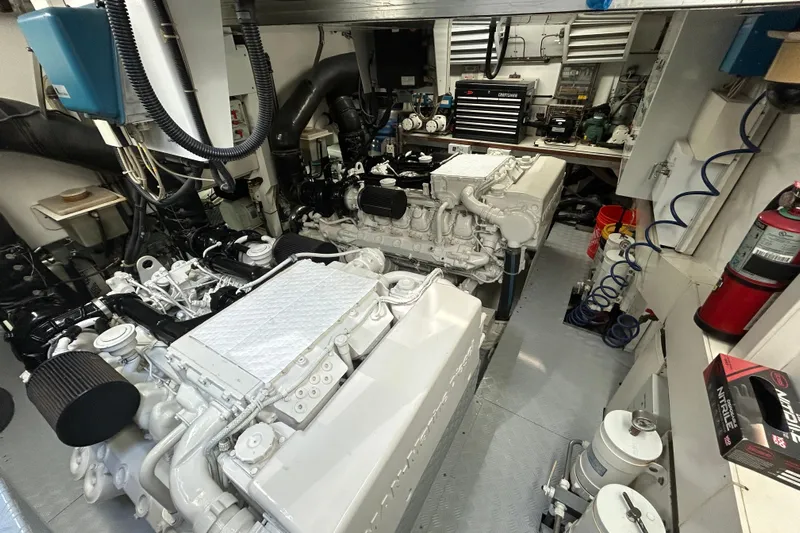 Gabriela G Yacht Photos Pics Engine room of a 2001 Mangusta 72 yacht, featuring dual engines and maintenance tools.
