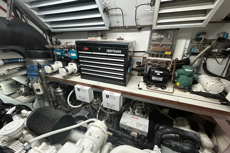 Gabriela G Yacht Photos Pics Engine room of 2001 Mangusta 72 yacht with tools and machinery.