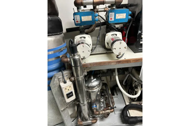 Gabriela G Yacht Photos Pics Engine room components of a 2001 Mangusta 72 yacht, featuring pumps and piping.