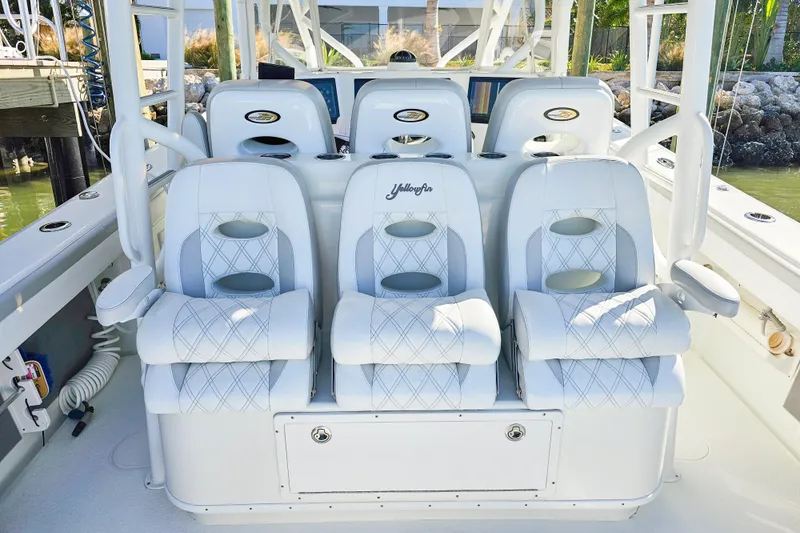 Contingensea Yacht Photos Pics Luxurious seating on 2015 Yellowfin 42 Offshore boat, featuring white cushioned chairs.