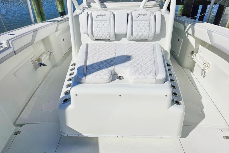 Contingensea Yacht Photos Pics 2015 Yellowfin 42 Offshore boat interior with cushioned seating and rod holders.