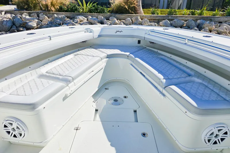 Contingensea Yacht Photos Pics 2015 Yellowfin 42 Offshore boat interior with white cushioned seating and speakers.