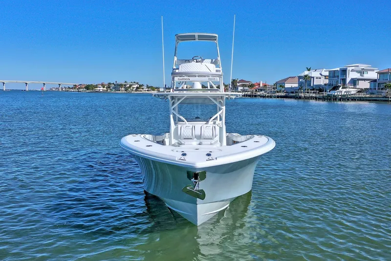Contingensea Yacht Photos Pics 2015 Yellowfin 42 Offshore boat on calm water near coastal homes.