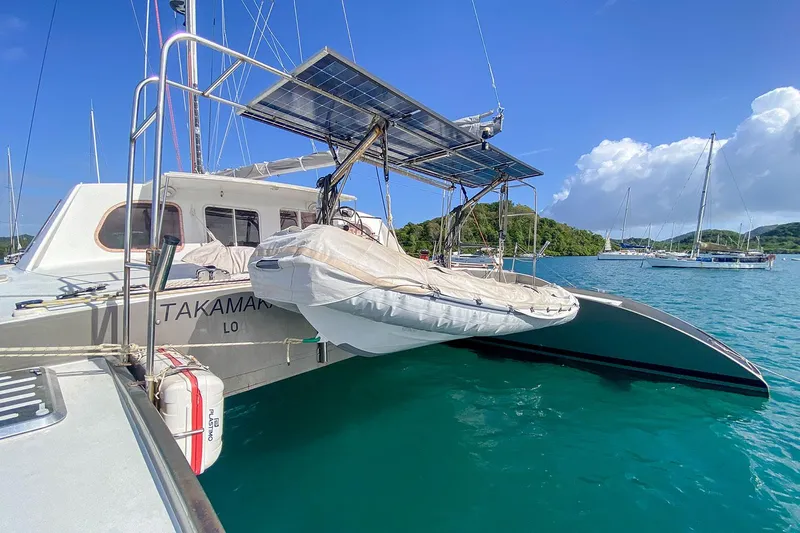  Yacht Photos Pics Custom BBL 54' catamaran with solar panels docked in clear blue water, 2004 model.