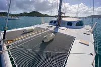 Custom BBL 54' catamaran on water, 2004 model, with netted deck and scenic background.