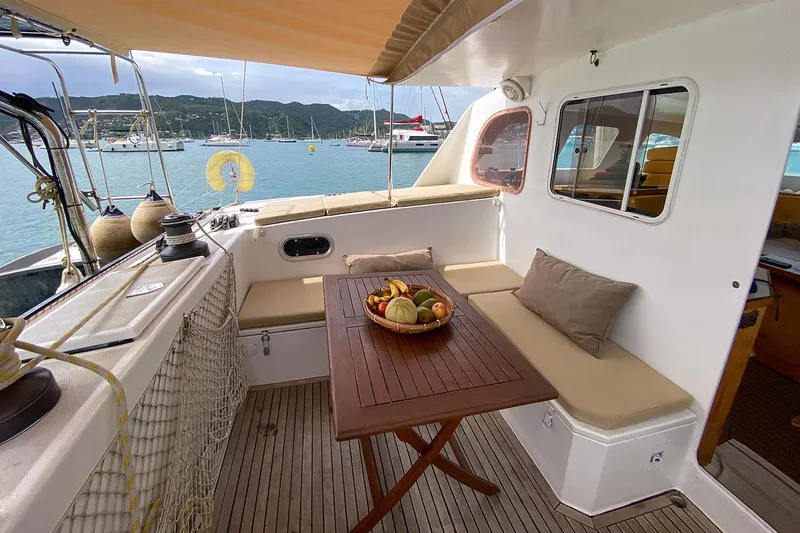  Yacht Photos Pics Outdoor seating area on a 2004 Custom BBL 54' yacht with a fruit bowl on the table.