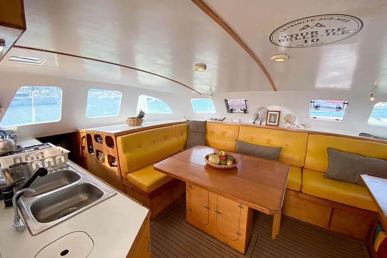  Yacht Photos Pics Luxurious 2004 Custom BBL 54' yacht interior with yellow seating and wooden dining table.