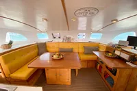 Luxurious interior of 2004 Custom BBL 54' yacht with cozy seating and dining area.