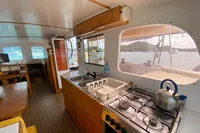 Interior of 2004 Custom BBL 54' boat with kitchen and scenic window view.
