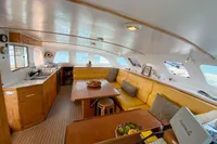 Interior of 2004 Custom BBL 54' yacht with cozy seating and kitchen area.