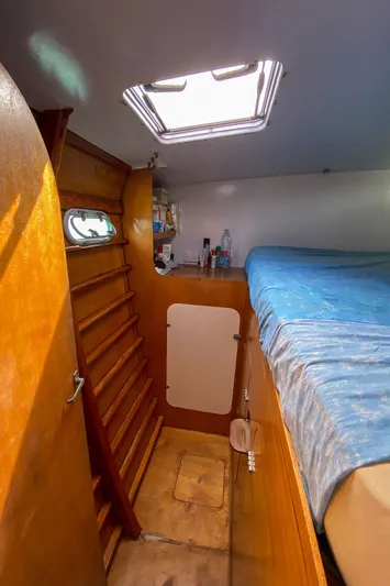  Yacht Photos Pics Interior of 2004 Custom BBL 54' boat cabin with wooden finish and blue bedding.