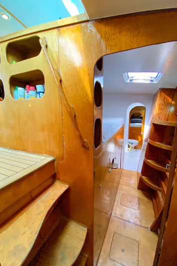  Yacht Photos Pics Interior of 2004 Custom BBL 54' yacht with wooden finishes and storage shelves.