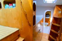 Interior of 2004 Custom BBL 54' yacht with wooden finishes and storage shelves.