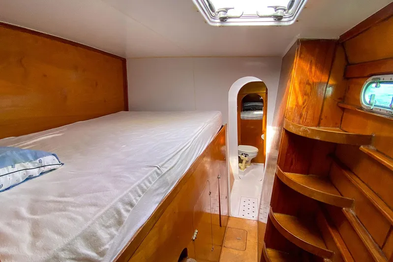  Yacht Photos Pics Cozy cabin interior of 2004 Custom BBL 54' yacht with wooden finishes and bed.