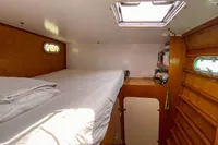 Cozy cabin interior of 2004 Custom BBL 54' with wooden finish and natural light.