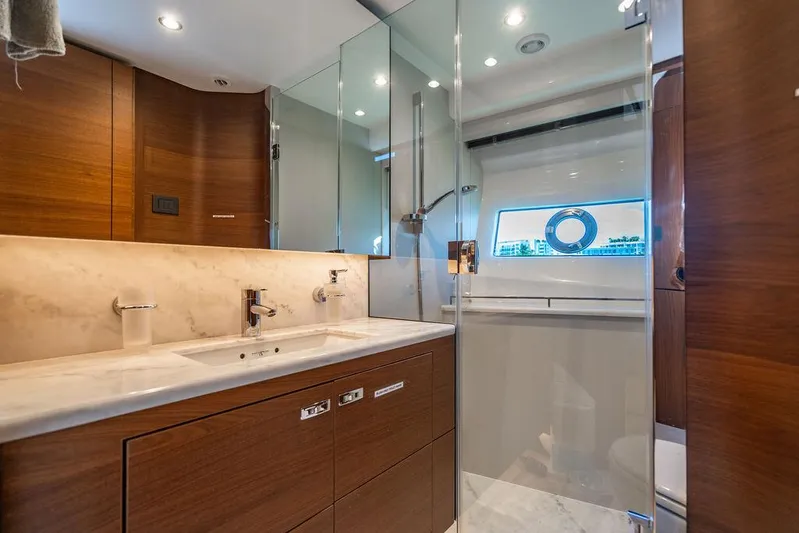 Cocoon Yacht Photos Pics Luxurious bathroom in 2021 Princess S78 yacht with modern fixtures and elegant wood finishes.