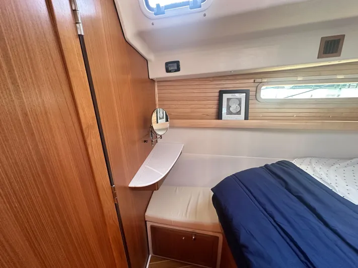 C426 #115 Yacht Photos Pics Interior of 2025 Catalina 426 yacht cabin with wooden paneling and cozy bed.