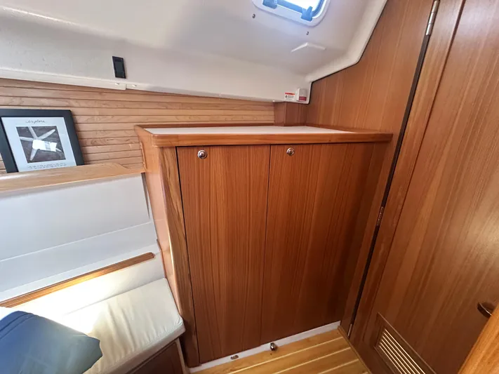 C426 #115 Yacht Photos Pics 2025 Catalina 426 yacht interior with wooden cabinetry and seating area.