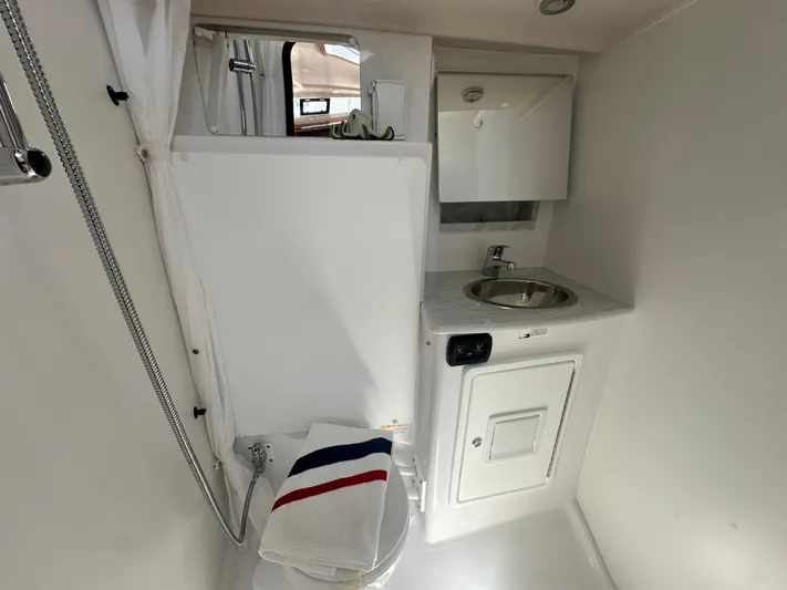 C426 #115 Yacht Photos Pics Compact bathroom in 2025 Catalina 426 yacht with sink, shower, and towel.