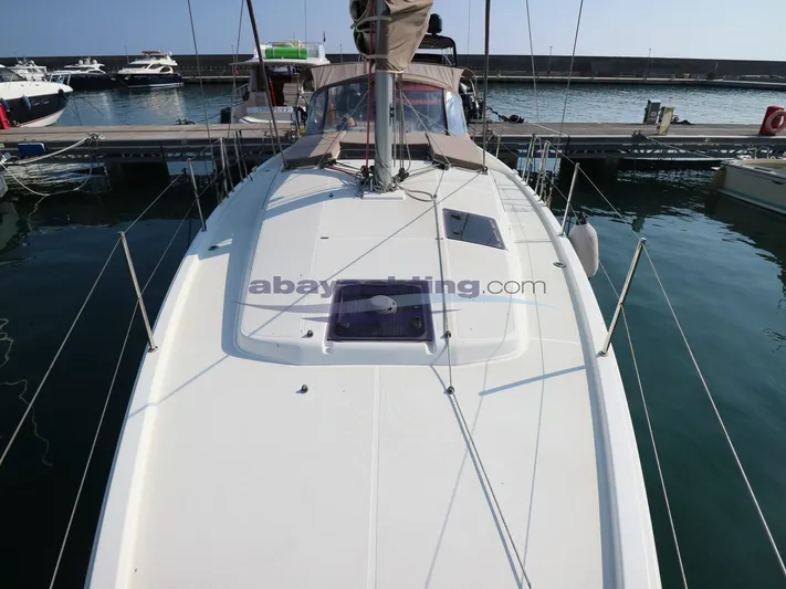 Yacht Photos Pics 2019 Jeanneau Sun Odyssey 410 sailboat docked at marina, viewed from deck.