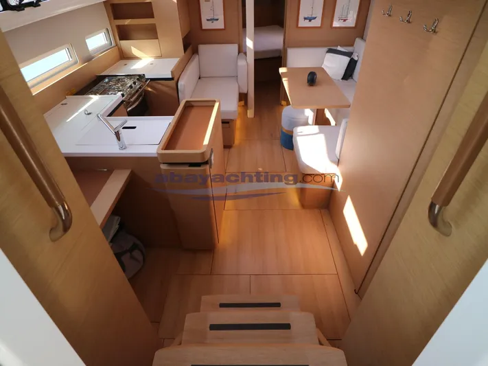  Yacht Photos Pics Interior of 2019 Jeanneau Sun Odyssey 410 yacht, featuring modern kitchen and seating area.