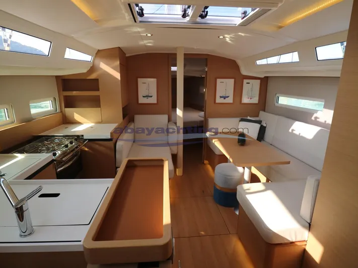  Yacht Photos Pics Interior of 2019 Jeanneau Sun Odyssey 410 yacht with modern kitchen and seating area.