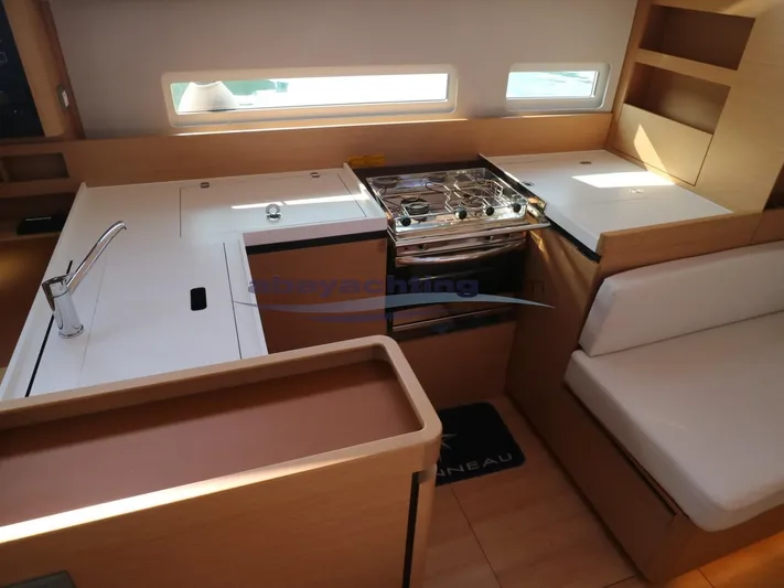  Yacht Photos Pics Interior of 2019 Jeanneau Sun Odyssey 410 yacht, featuring modern kitchen and seating area.