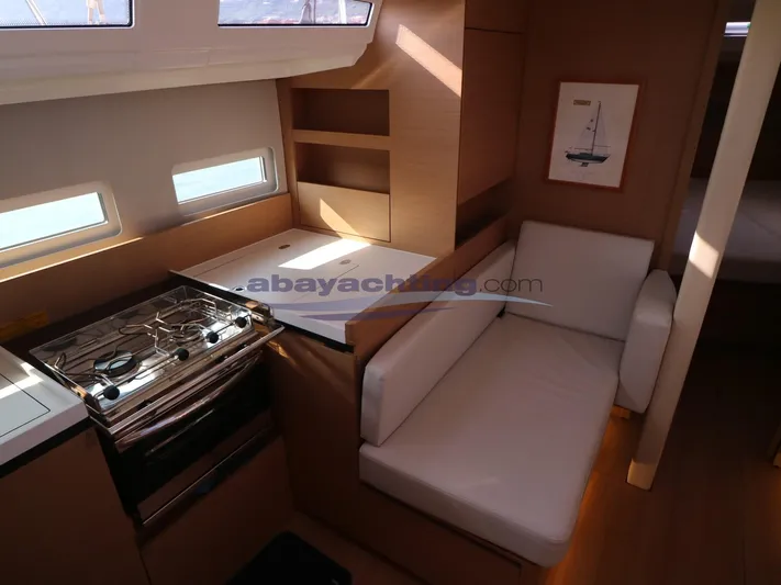  Yacht Photos Pics Interior of 2019 Jeanneau Sun Odyssey 410 yacht with kitchen and seating area.